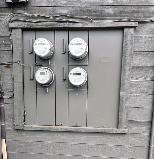 Older analog electric meters on an East Bay building