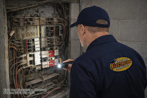 Licensed electrician performing electrical panel upgrade in East Bay home